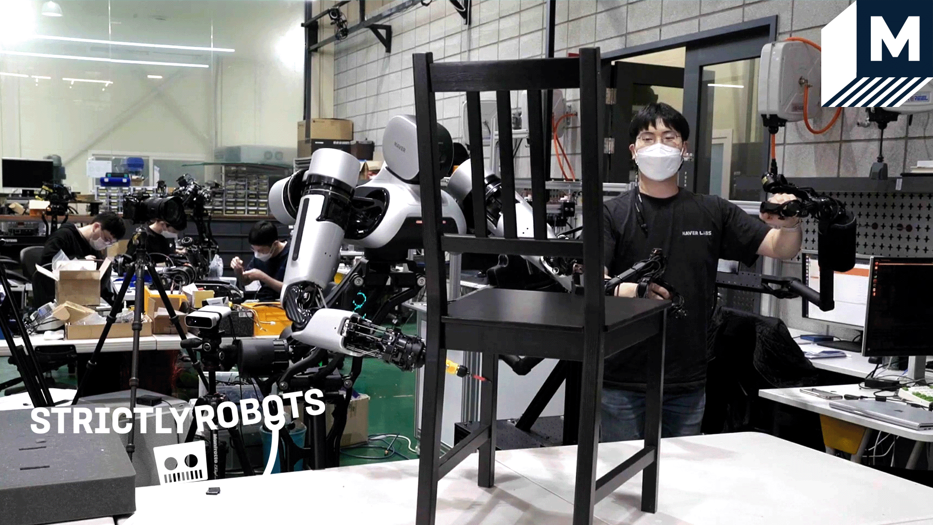 A robot assembling an IKEA chair with the help of a human using a haptic feedback device.