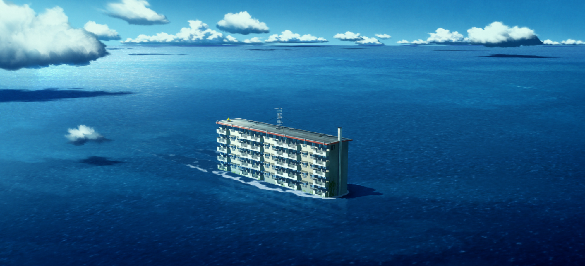 An apartment building floating in the middle of the ocean.