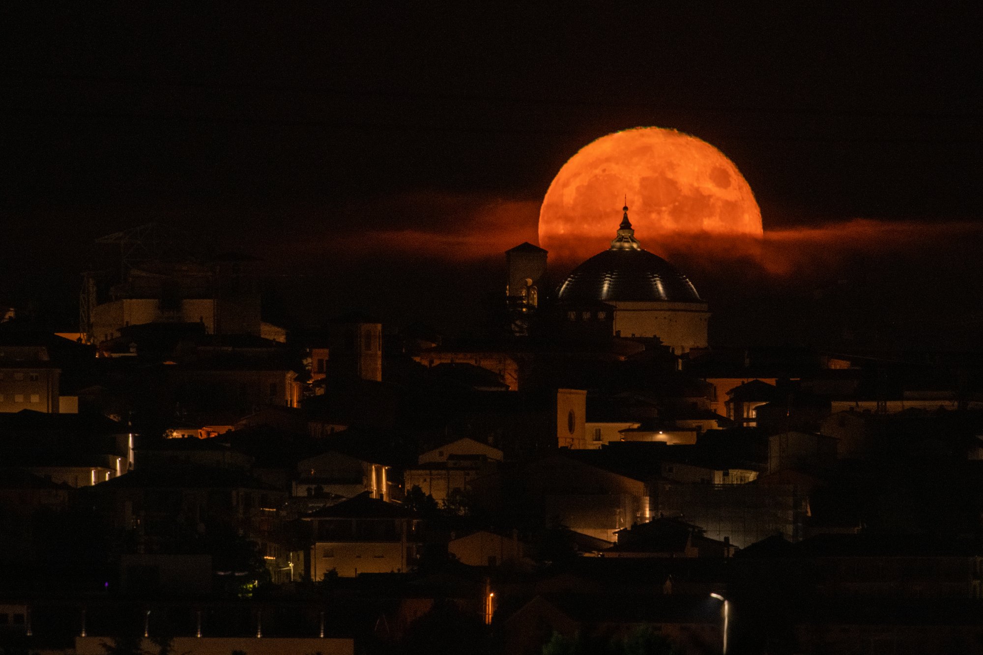 The orange Sturgeon Moon over Abruzzo, Italy.