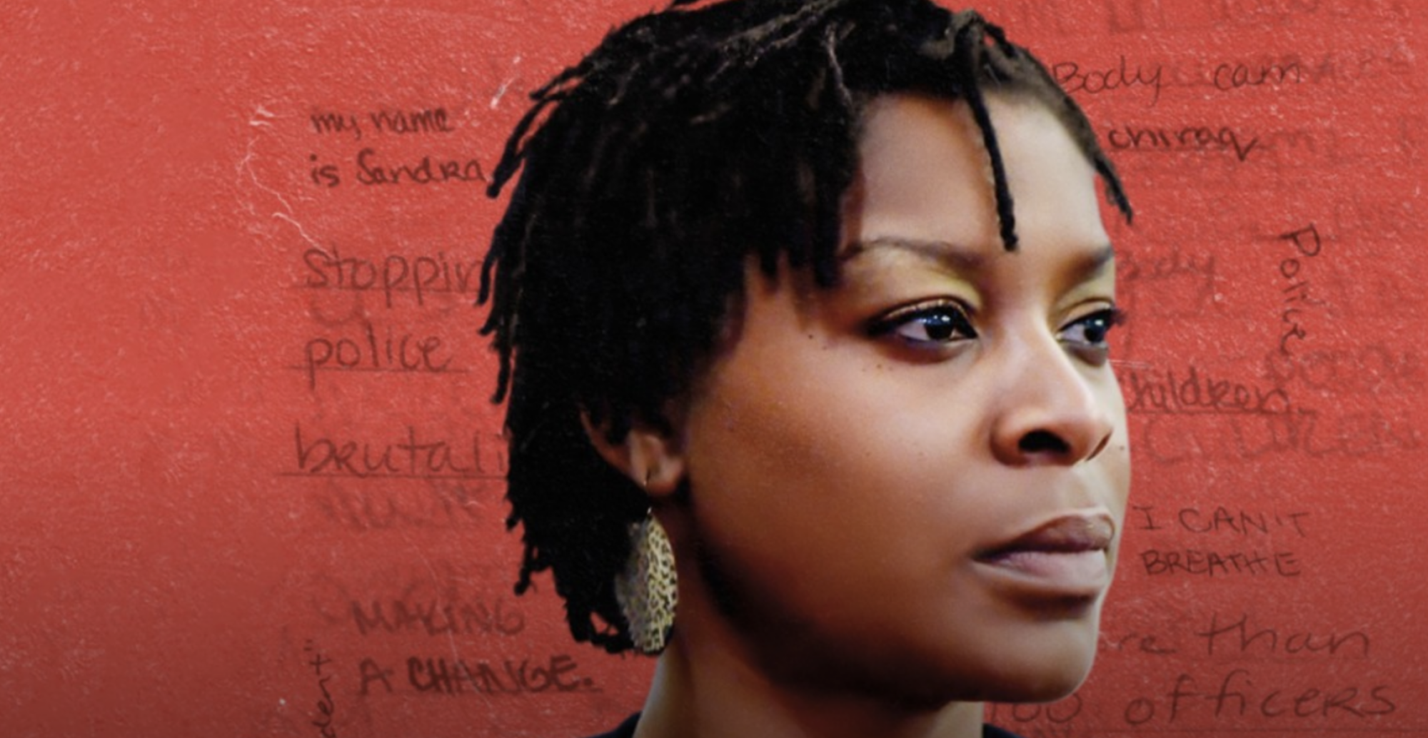 Sandra Bland in front of a red background