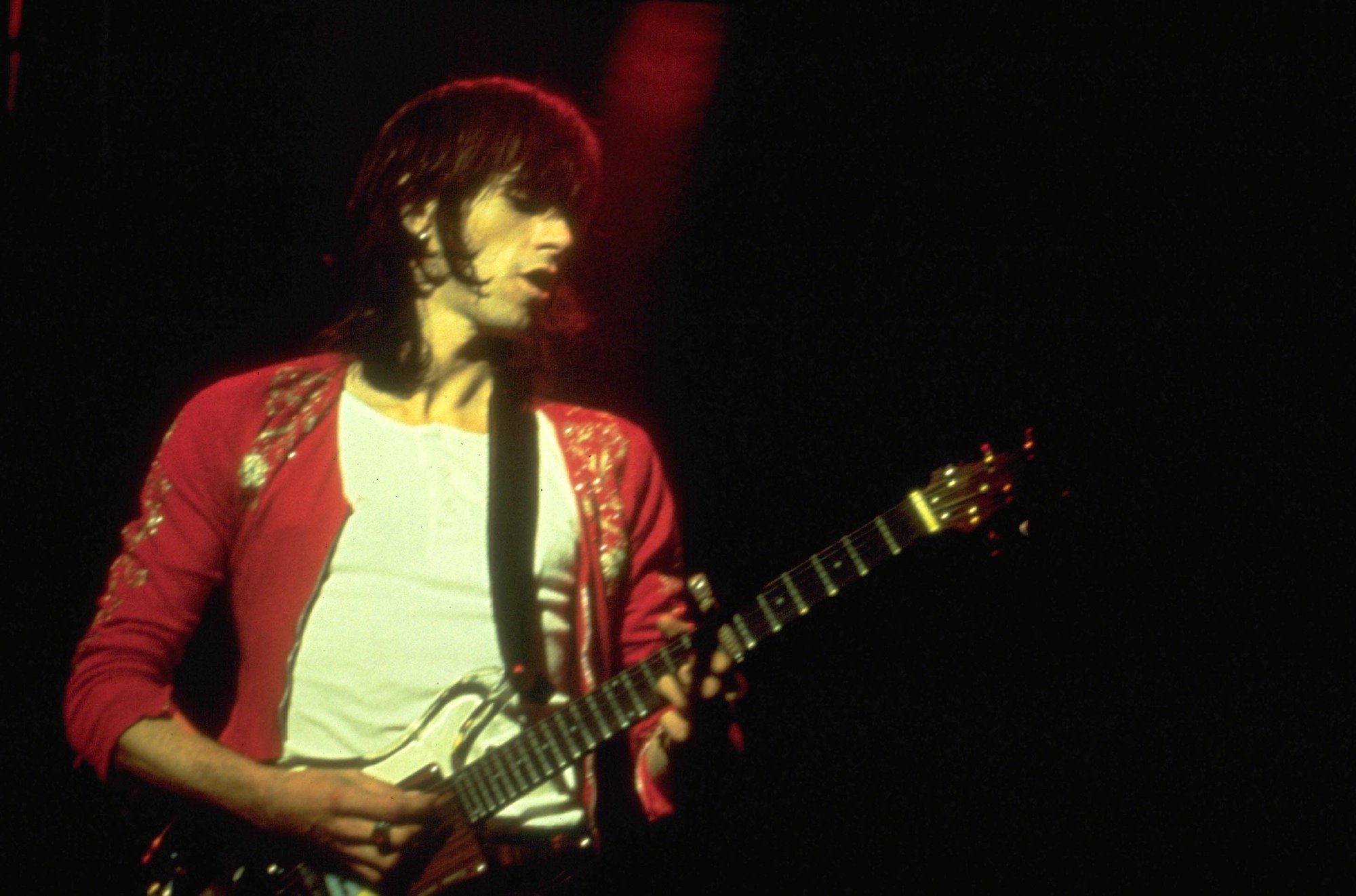 Keith Richards playing guitar onstage at a Rolling Stones concert.