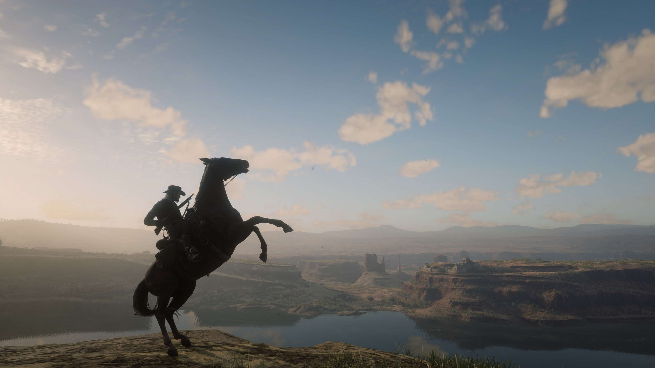 A beautiful vista in Red Dead Redemption 2 with a horse in the foreground running on Nvidia graphics with DLSS