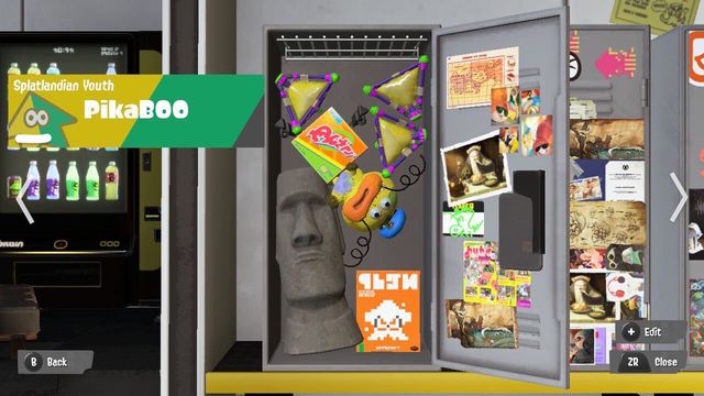 an image of a virtual locker in splatoon 3. there is a stuffed zapfish, a Moai head statue, a box of laundry detergent, and three splatbombs. 
