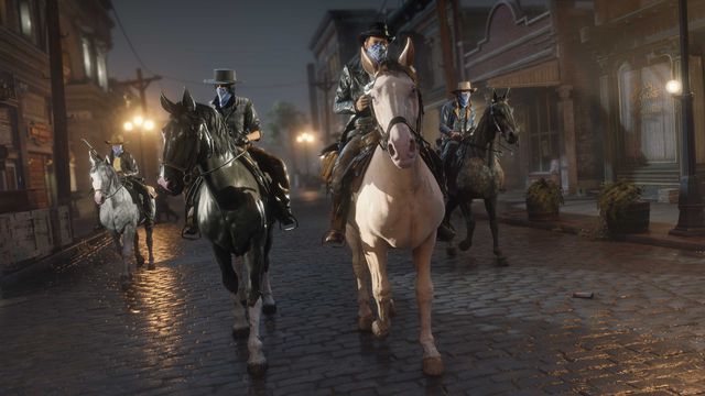 Red Dead Online - four players, equipped in cowboy gear, head through the streets of Saint Denis atop their horses.