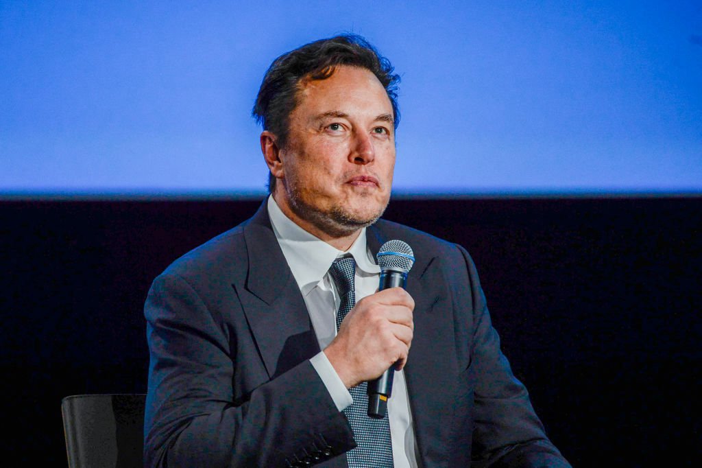 Elon Musk on stage at an event