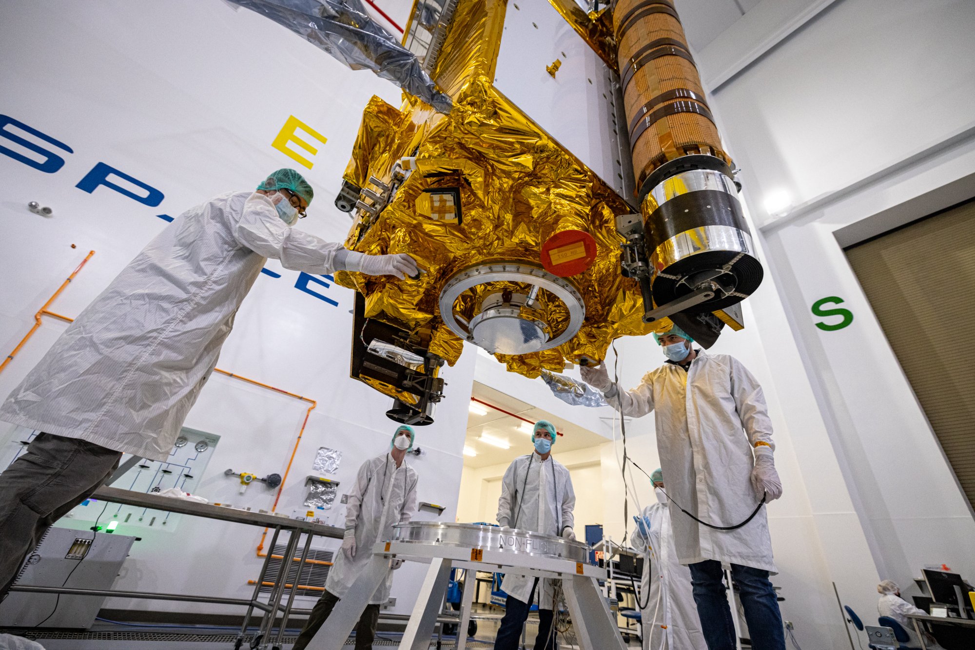 NASA engineers lowering the DART spacecraft