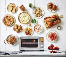Silver smart oven pro surrounded by thanksgiving dishes
