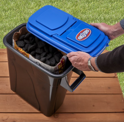 Someone taking the lid off of a charcoal storage container