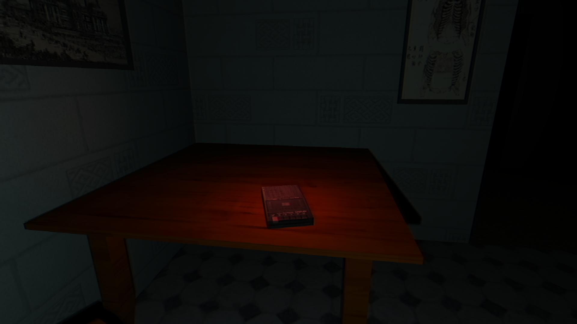 A tape recorder bathed in red light sits on a table