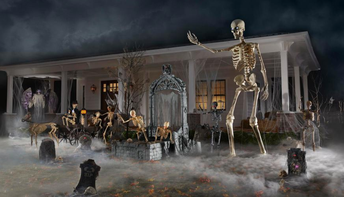 12-foot skeleton in front yard of home with other Halloween decorations