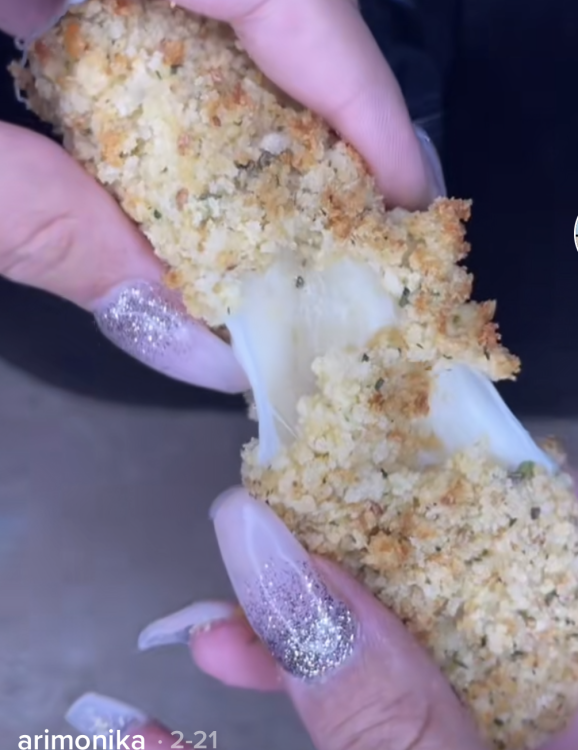 mozzarella stick being pulled apart by fingers