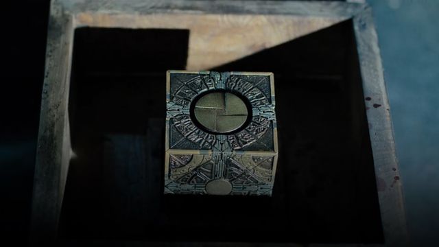 The “Lament” configuration of the puzzle box from Hellraiser (2022), encased in a wooden box.