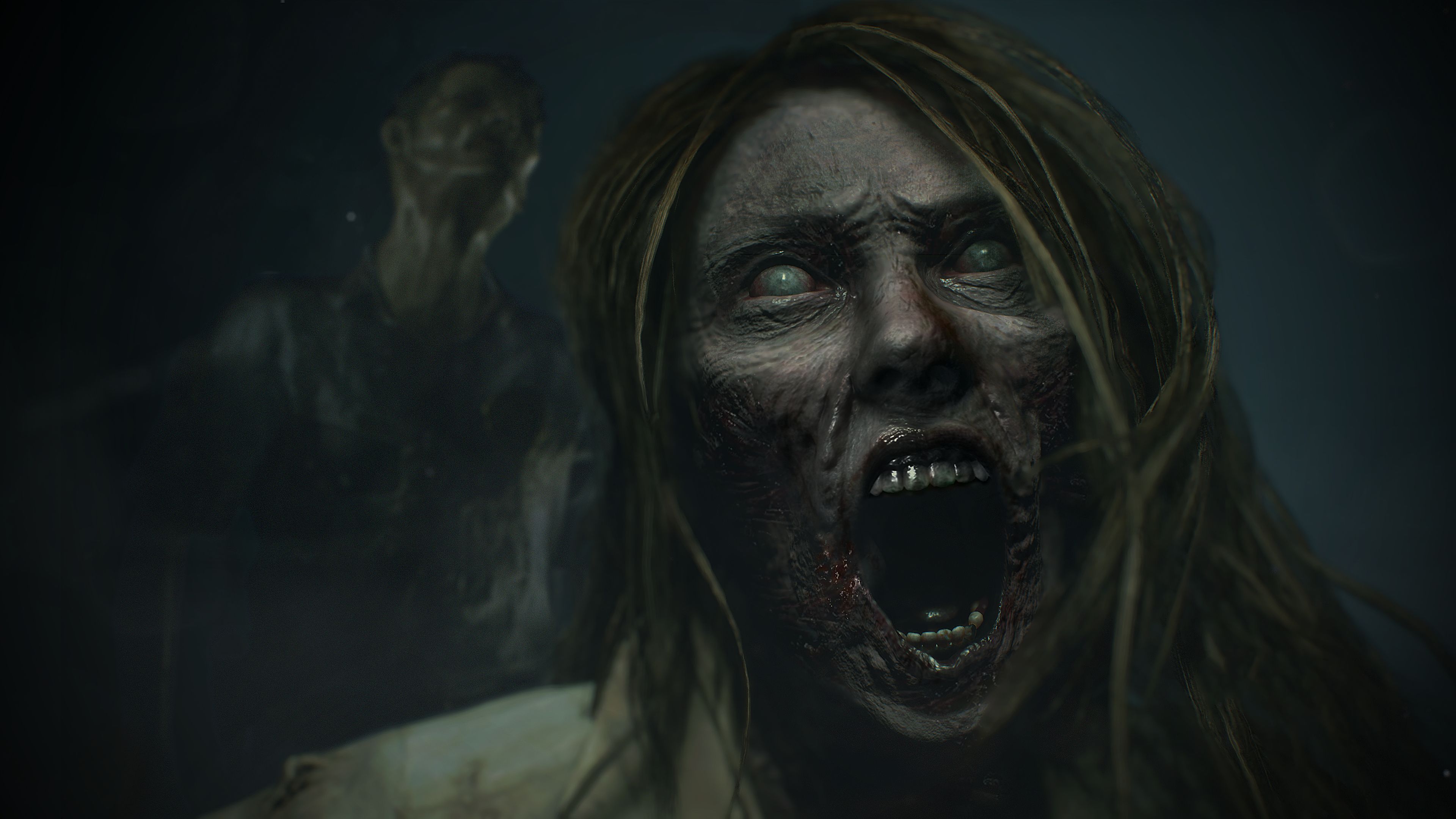 A zombified woman's face up close, screaming