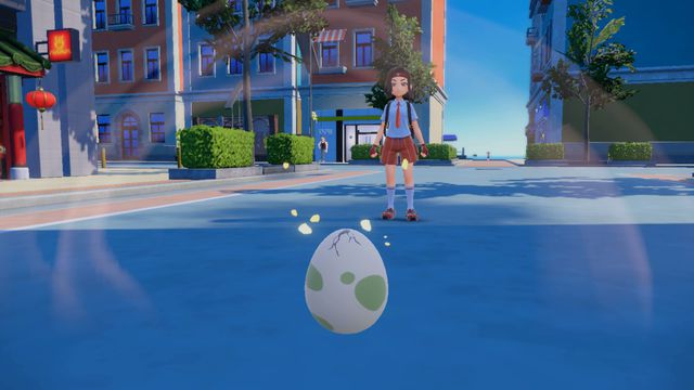 A Pokémon egg hatches in the middle of a city. A trainer stares at it in awe