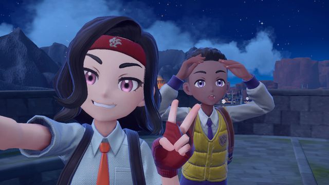 Two Pokémon trainers take selfies together. One throws up a piece sign and the other one shades their eyes to look into the distance