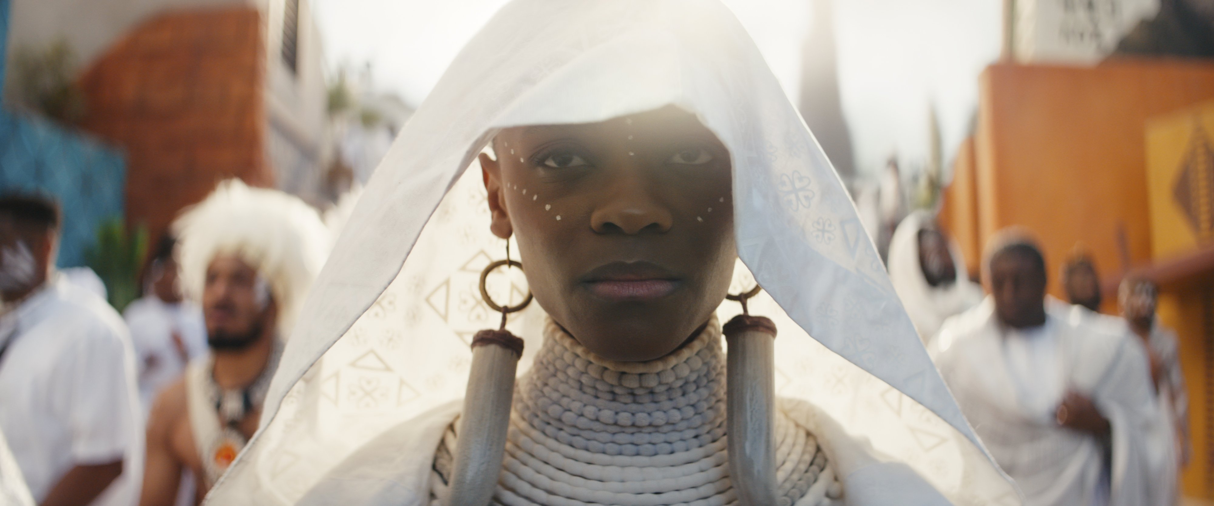 A young Black woman in a white mourning costume.