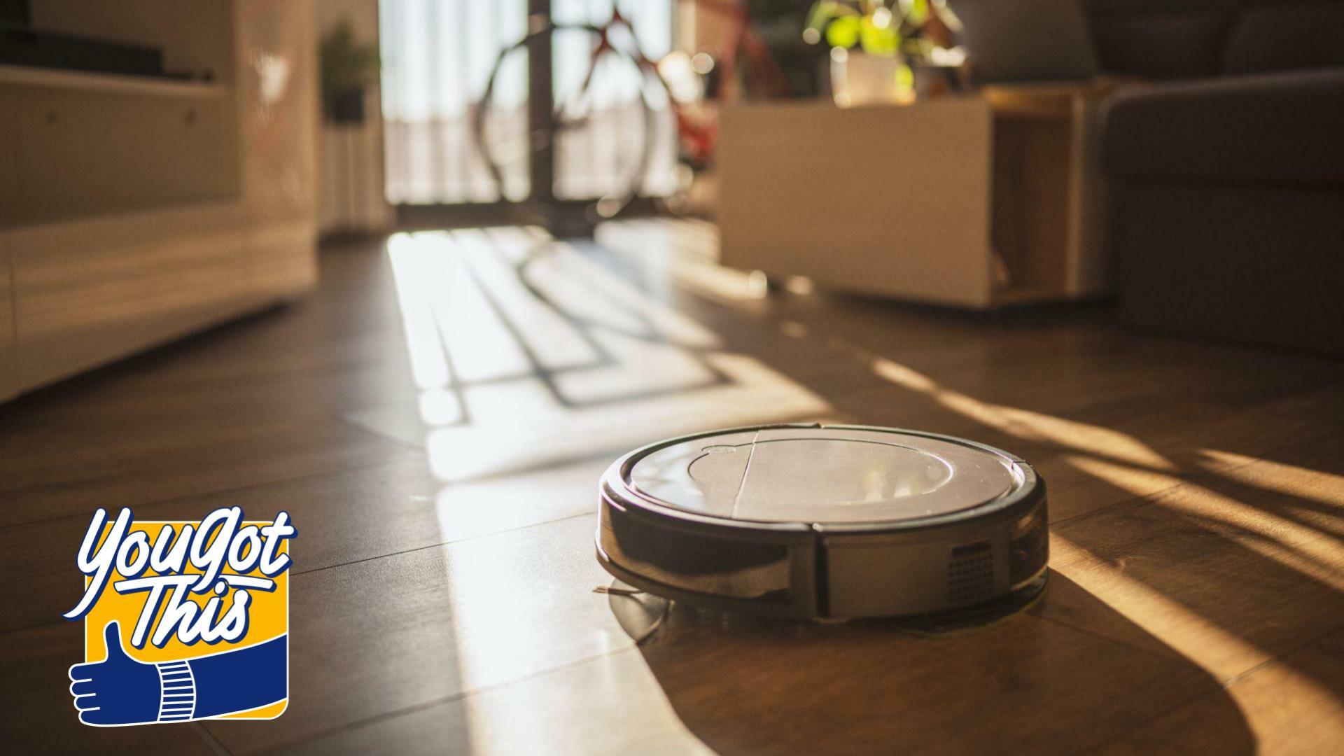 robot vacuum in living room with coach, balcony, and bike