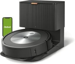 Black and silver robot vacuum with phone on iRobot screen
