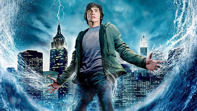 Official artwork shows logan lerman as percy Jackson with a city behind him