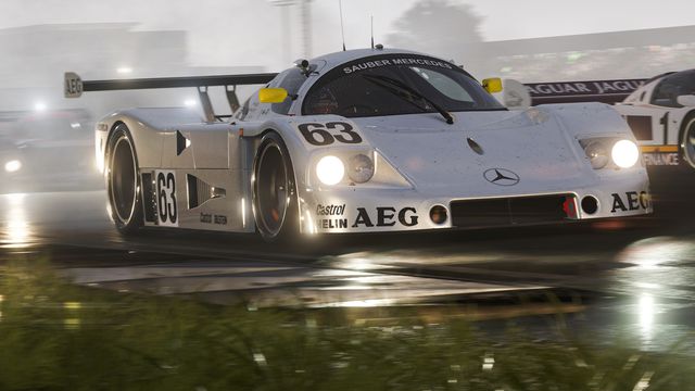 A Mercedes competition-level touring car leads the field on a rain-slicked track, headlights burning, in Forza Motorsport.