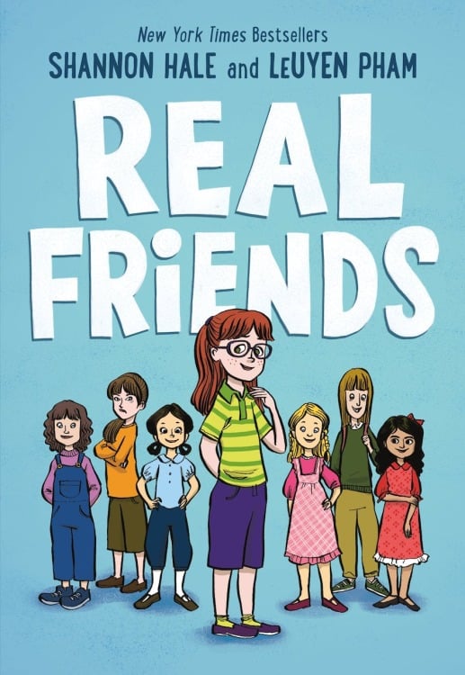 The book cover for "Real Friends." An illustration of seven diverse preteens standing next to each other with a blue background.